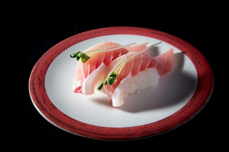 tuna sushi on plate, black backgroundの写真素材
