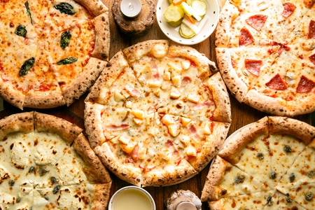 variety of pizzas like four-cheese, hawaiian, blueberry cheese pizzas, top viewの写真素材