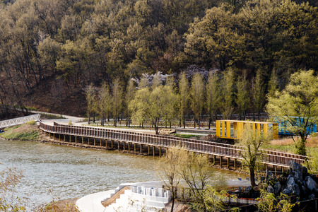 Scenery of park with lake and bridgeの写真素材
