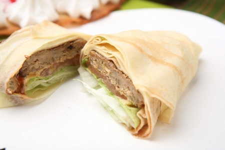pork quesadilla with cabbage cut in half on white plate