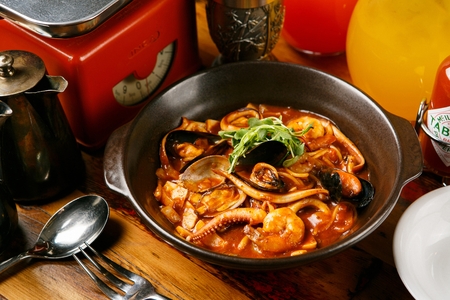 Seafood pot pasta on a wooden tableの写真素材