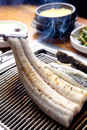 Eels being grilled on charcoal