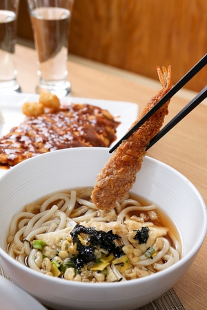 Udon with fried shrimp, on a plate, on a tableの写真素材