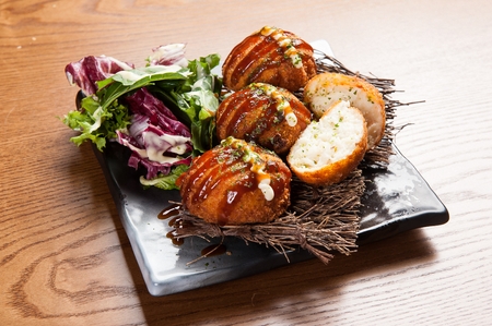 Croquette put in sauce, on a plate, on a tableの写真素材