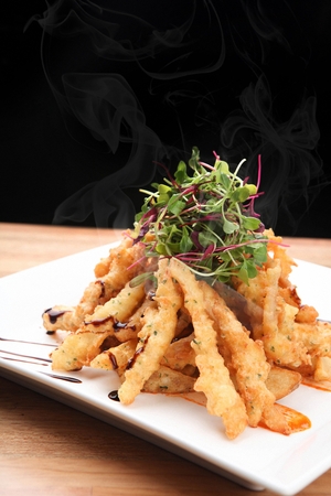Fried squid on a plate, on a tableの写真素材