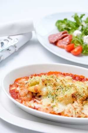Cheese seafood gratin on a white plate, on a white tableの写真素材