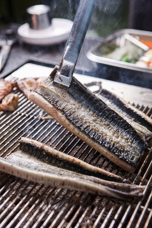 Eels being grilled on charcoalの写真素材