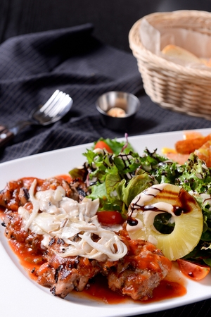 Chicken plate on a long white plate, on a tableclothの写真素材