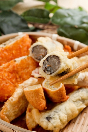 Fried fish cakes and fried glass-noodles in seaweed in a basketの写真素材