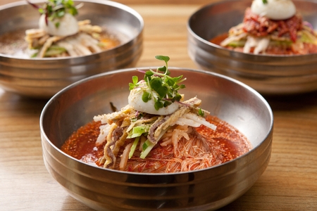 Bibim kuksu, a korean noodle dish which mixes noodles, vegetables and spicy seasoning, with boiled eggの写真素材