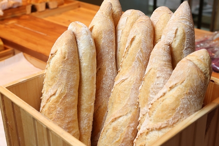Long baguettes arranged in bakery
