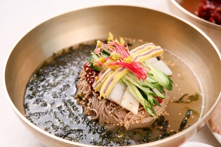 Korean cuisine, mulmakguksu, cold broth noodles with cucumber, on nickel silver bowlの写真素材