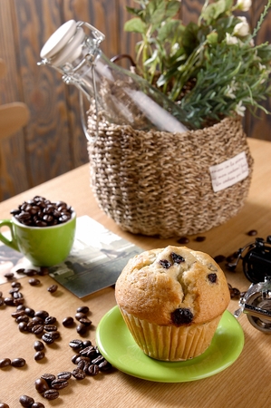 Blueberry muffin in plate, on wooden tableの写真素材