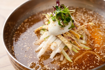 famous Korean cuisine, Mul Naengmyeon, buckwheat noodles served in chilled soup made of dongchimi (radish kimchi) and beef brothの写真素材