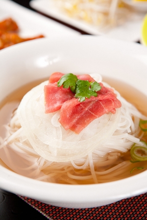 Vietnamese cuisine, ssalguksu, noodles with cilantro on top on white bowl, close-upの写真素材