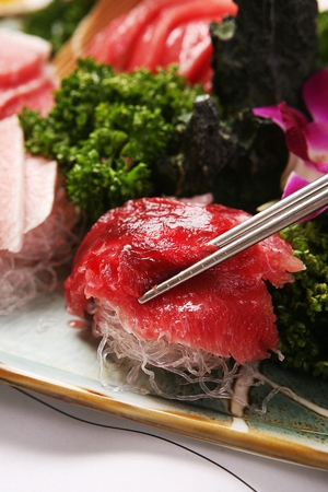 Chopsticks grabbing tuna sashimiの写真素材