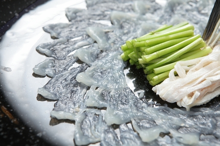 Bokeo hwe, abalone sashimi, raw abalones cut thinly, on black plate