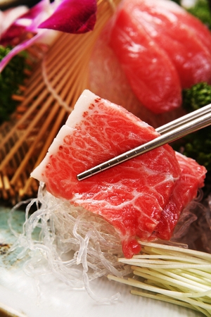 Chopsticks grabbing tuna sashimiの写真素材