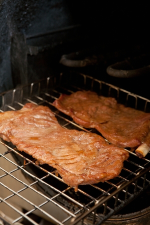 Marinated pork rib, being grilledの写真素材