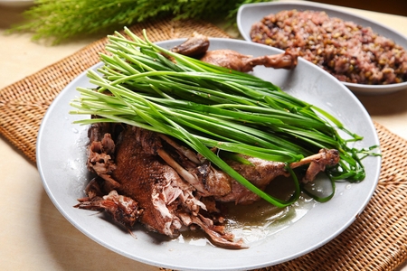 Duck soup with rice, a Korean cuisine, health food boiled with duck and medicine herbs, with chivesの写真素材