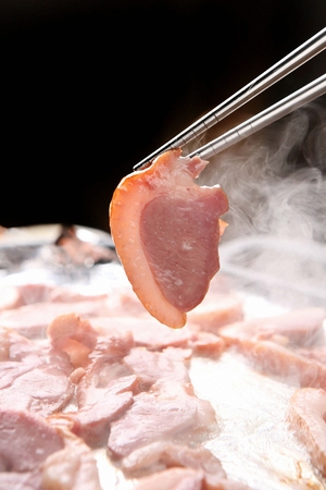 Chopsticks grabbing smoking hot smoked duckの写真素材