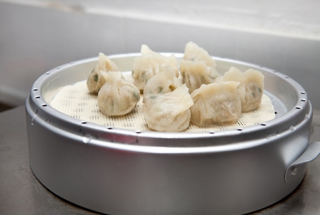 Steaming meat dumplings in a steel steamerの写真素材