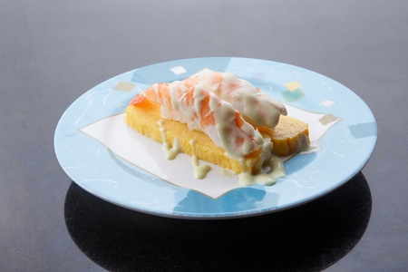 Shrimp sushi on egg with mayonnaise, on a round plateの写真素材