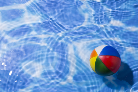 Summer holiday concept photo. vacation items and beach accessories in swimming pool or yellow...