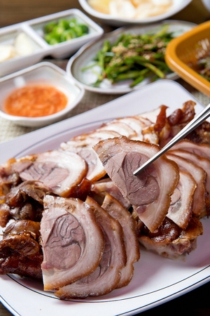 Chopsticks picking up Jokbal, thinly sliced boiled pork feetの写真素材