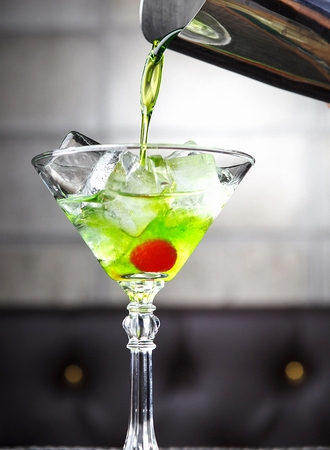 Green cocktail with ice in glassの写真素材