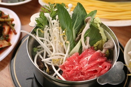 Shabu-shabu, thinly sliced beef and vegetables slightly parboiled in boiling brothの写真素材