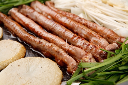 Pork tripes and potatoes, garlic, mushrooms, on grillの写真素材