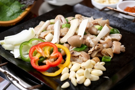 Tripes, mushrooms, onions, garlic, paprika, on black grillの写真素材