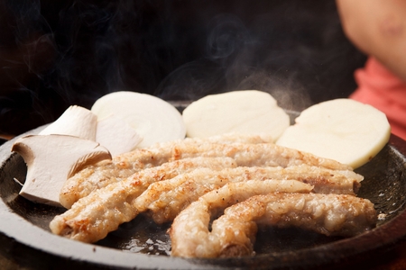 Beef intestines, potatoes, mushrooms, on black stone tabletsの写真素材