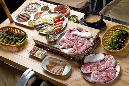 Meat, sausages, dumplings, side dishes, on plate, on tableの写真素材