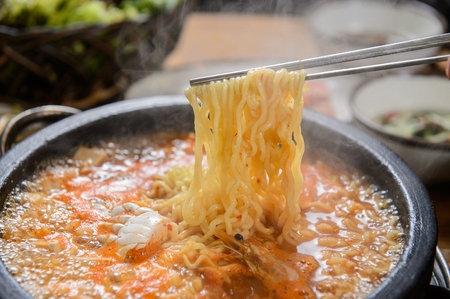 Bean paste stew with noodles, on pot, on tableの写真素材