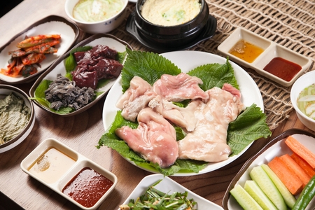 Beef and lamb tripes on perilla leaf, on white plateの写真素材