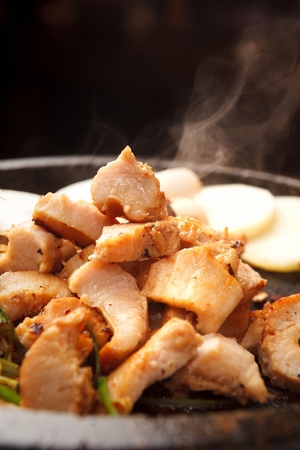 Spicy marinated pork tripes, on black grillの写真素材