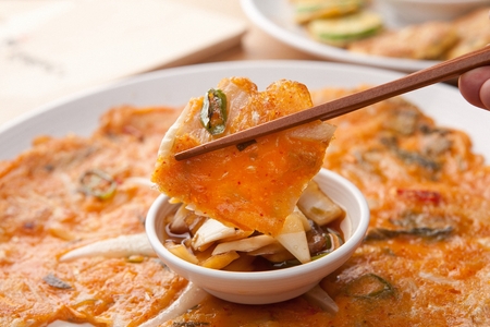 Kimchi pancakes and soy sauce on plateの写真素材