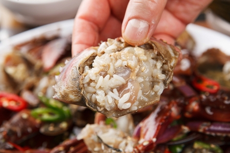 Crab shell mixed rice, made by mixing rice in soy sauce marinated crab shellの写真素材