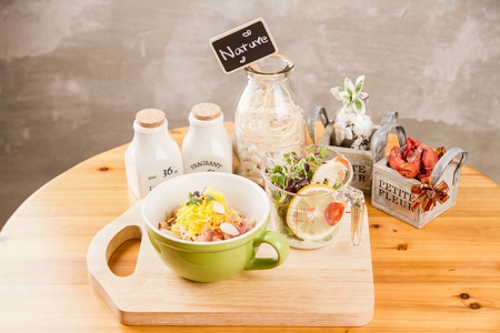 Bacon stir-fried rice with garlic flakes, in mug-shaped plate, on hardwood table