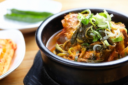 Pork rib hangover soup, pork ribs and vegetables boiled in spcy broth, in black potの写真素材