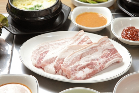 Pork belly and steamed eggs on white plateの写真素材