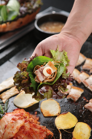 Perilla leaf, bean sprouts, pork belly, garlic and sauce on lettuceの写真素材