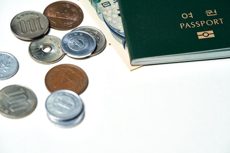 Closeup of Japanese Yen banknotes and Japanese Yen coin with Korean passportの写真素材