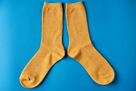 Top view of cute colorful socks on color backgroundの写真素材