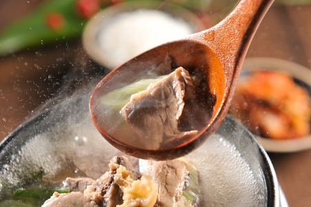 Ox bone soup with lots of welsh onion and meat, in potの写真素材