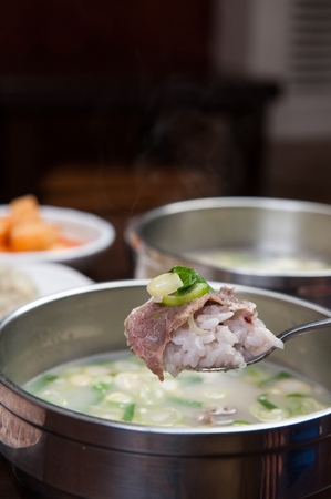 Ox bone soup with lots of welsh onion and meat, in grey bowlの写真素材
