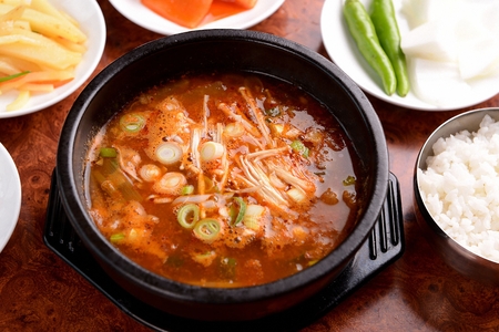 Spicy beef radish soup with welsh onion garnish, in potの写真素材