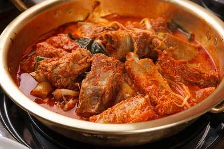 Braised spicy back ribs with bean sprouts, in nickel silver potの写真素材